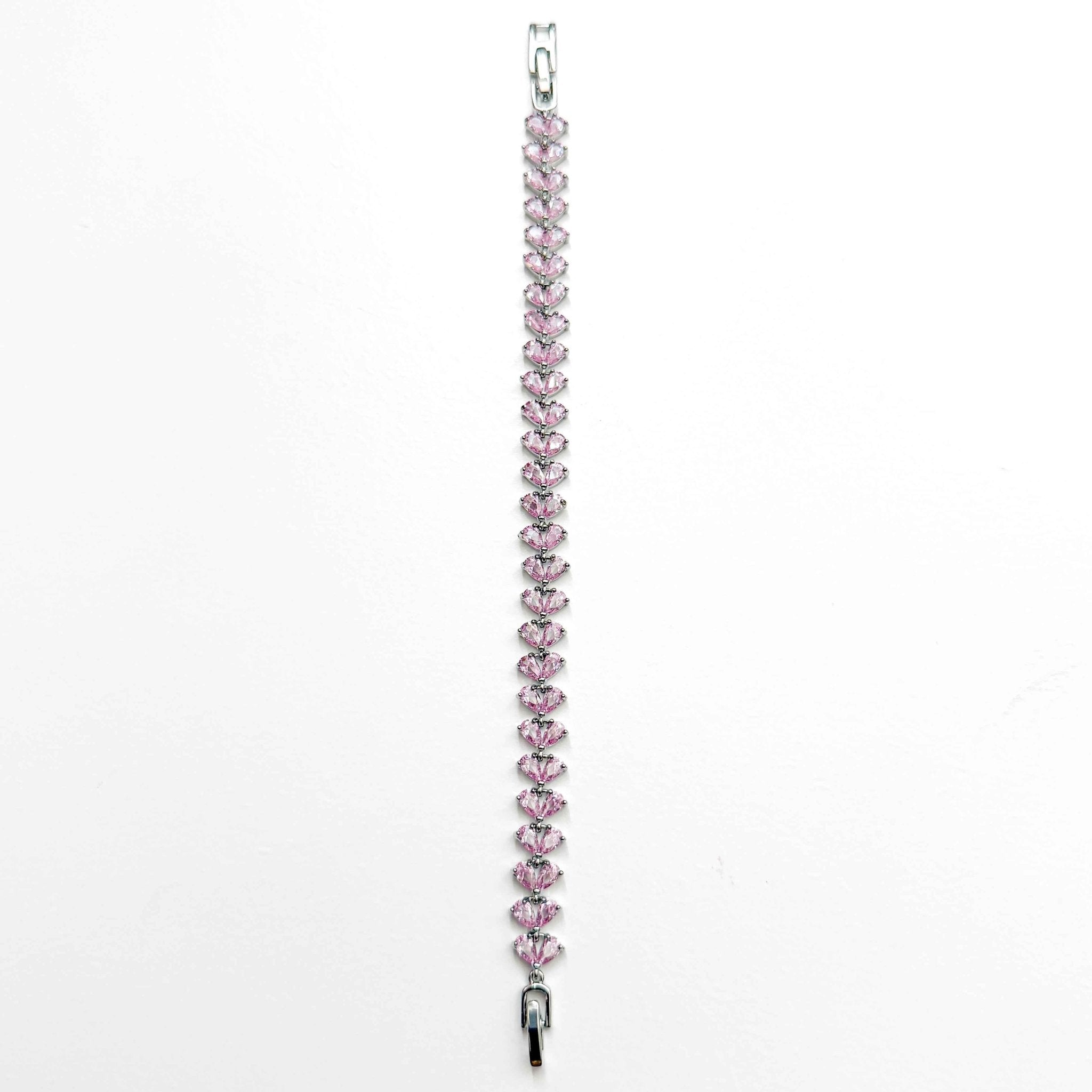 Pink CZ tennis bracelet featuring a row of pear-shaped pink stones with a small clasp end