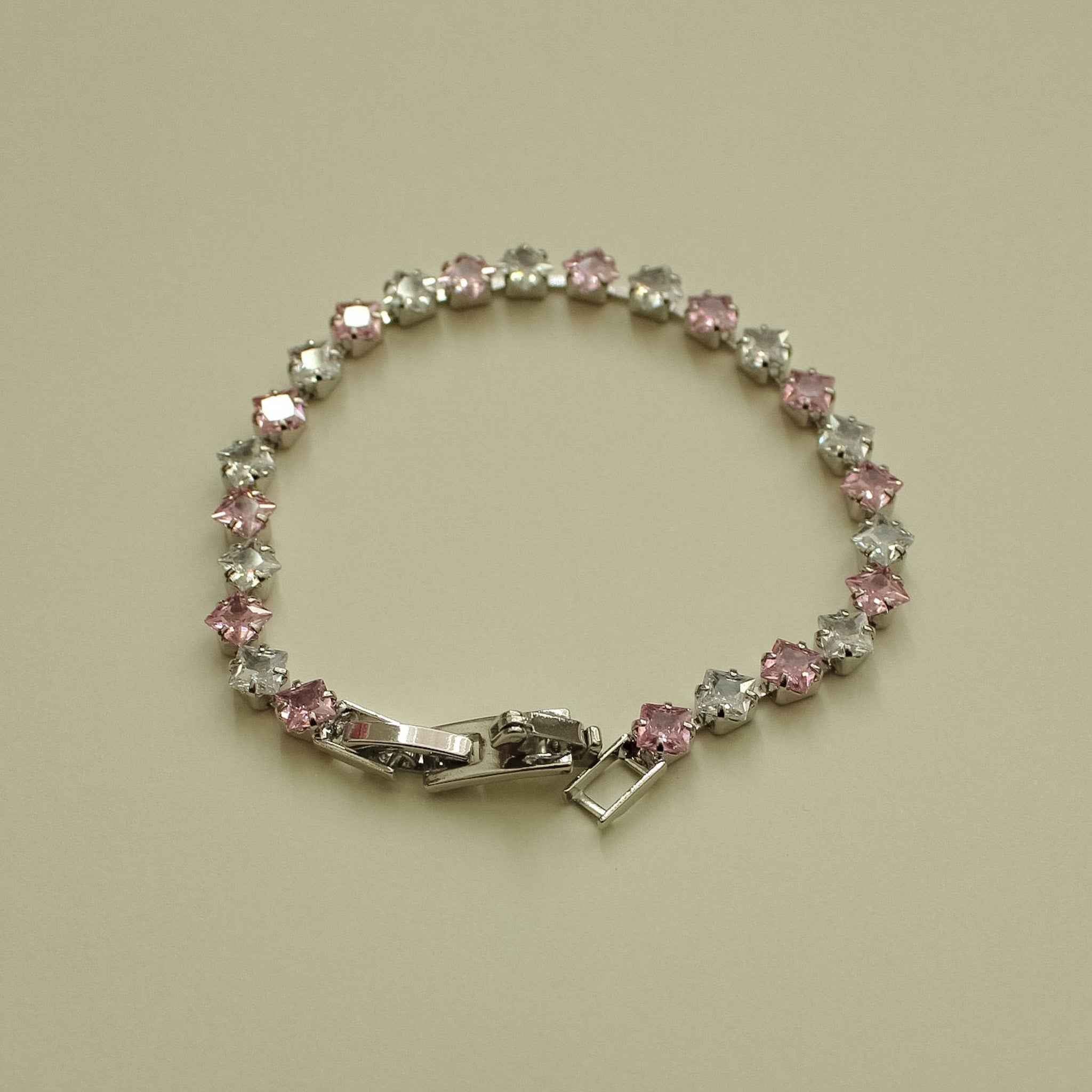 Tennis bracelet with pink and clear princess-cut CZ stones and hinged clasp