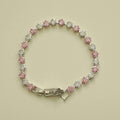 Tennis bracelet with pink and clear princess-cut CZ stones in round bezel settings