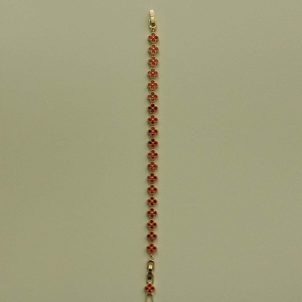 Gold-tone tennis bracelet with red CZ flower bead row and small clasp at top
