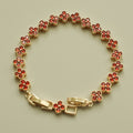 Gold-tone bracelet with red round CZ flower links and central toggle clasp