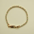 Gold-tone tennis bracelet with seafoam green stones, clear CZ accents, hinged clasp