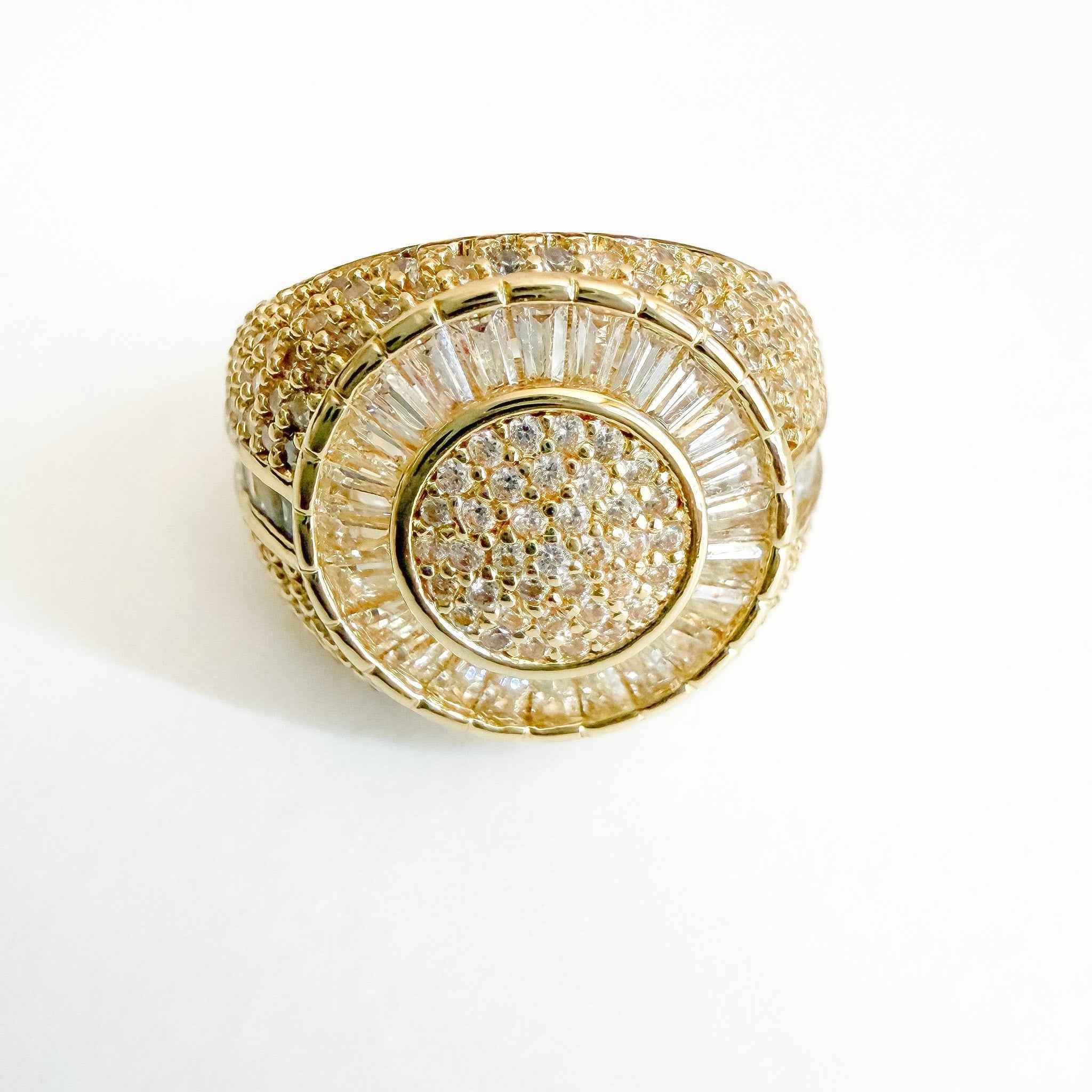 Gold-tone signet ring with pavé CZ circular face and vertical baguette accents