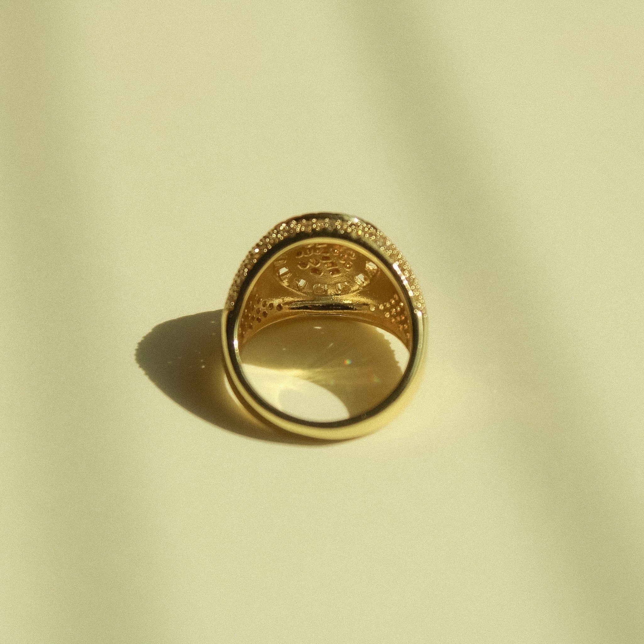 Gold-tone signet ring with round smoky center stone and pavé CZ rim
