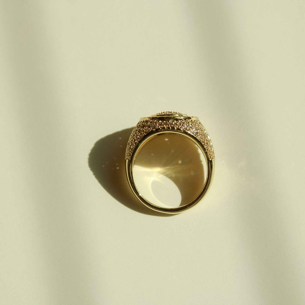 Gold-tone signet ring with round smoky stone and pavé CZ border