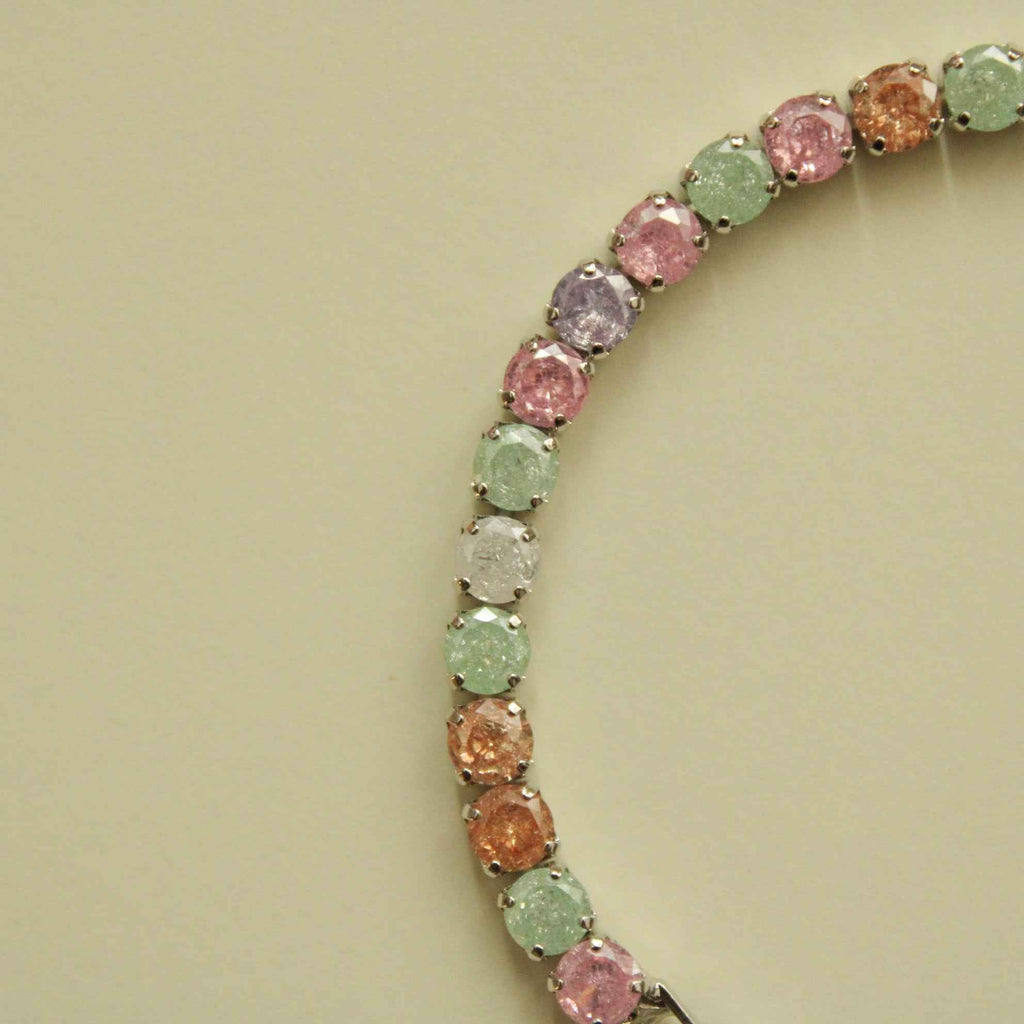 Multicolor CZ tennis bracelet with rounded pastel stones in a curved setting