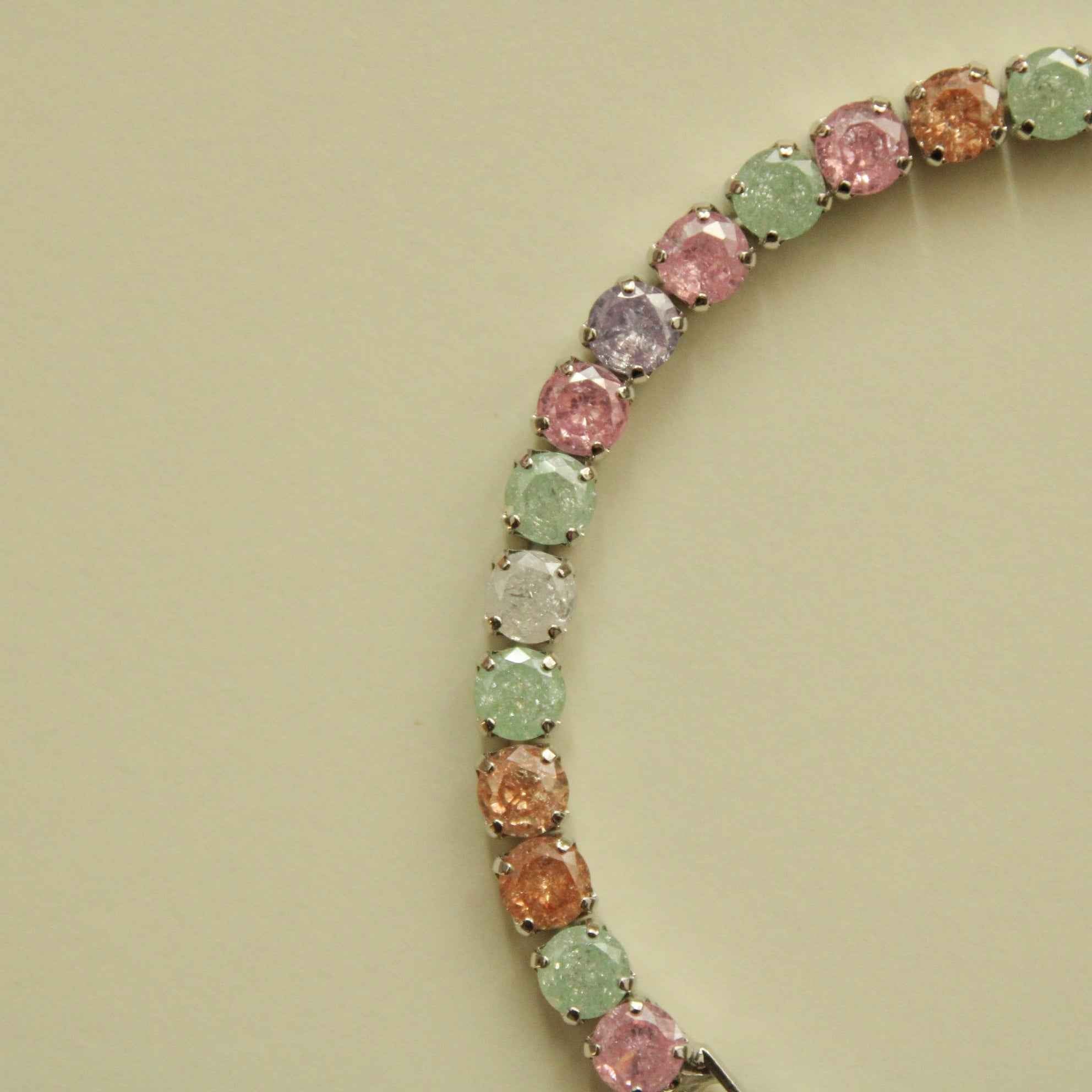 Multicolor CZ tennis bracelet with rounded pastel stones in a curved setting