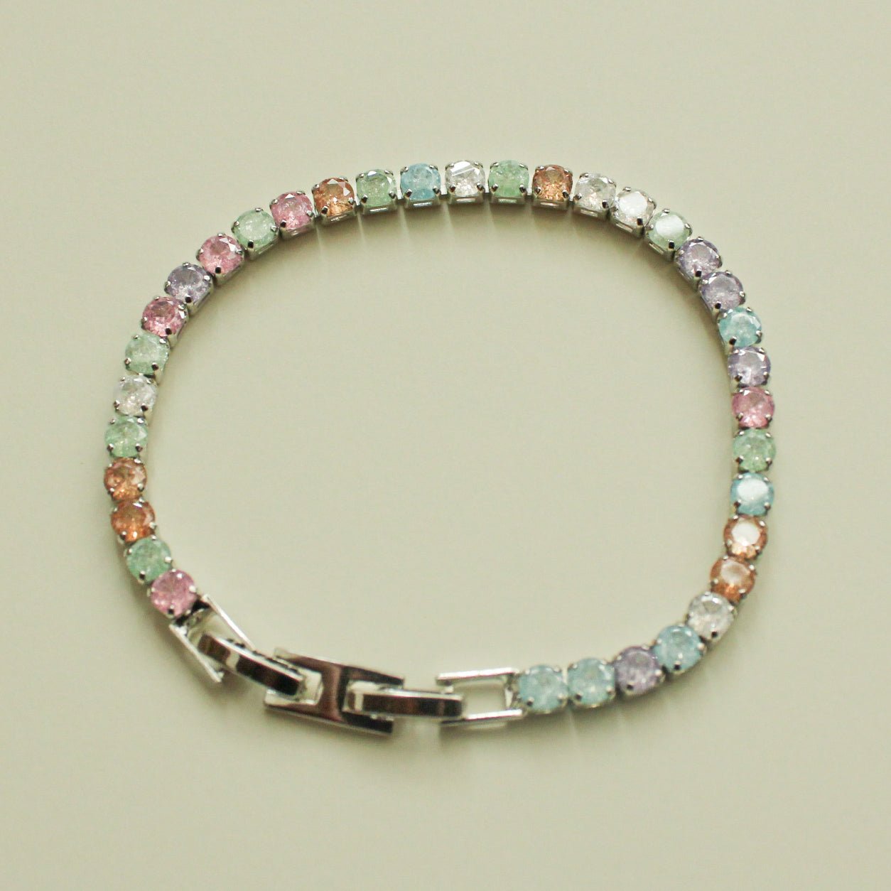 Multicolor CZ tennis bracelet in a round shape with pastel stones and clasp