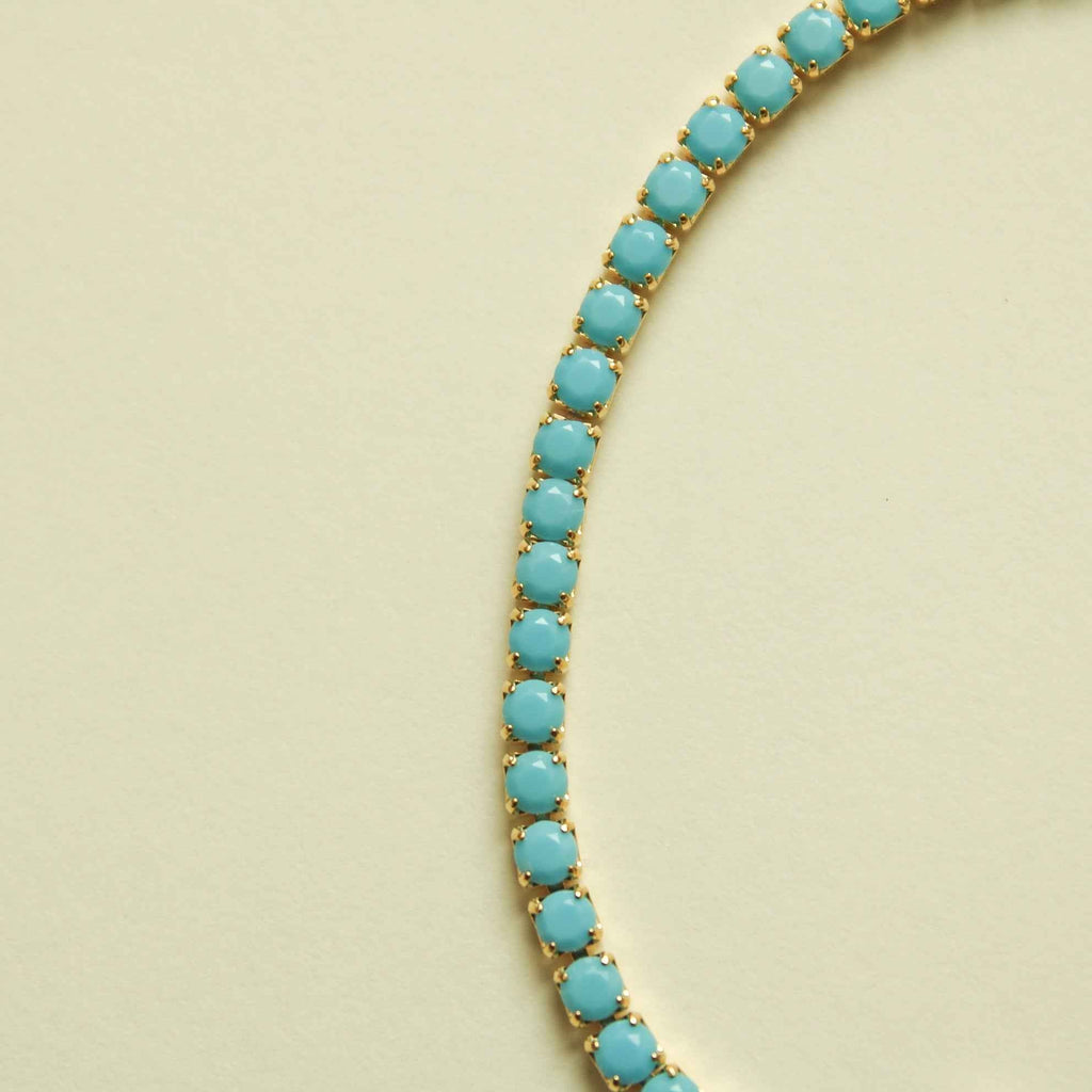 Turquoise beaded tennis bracelet strand with oval stones and gold links