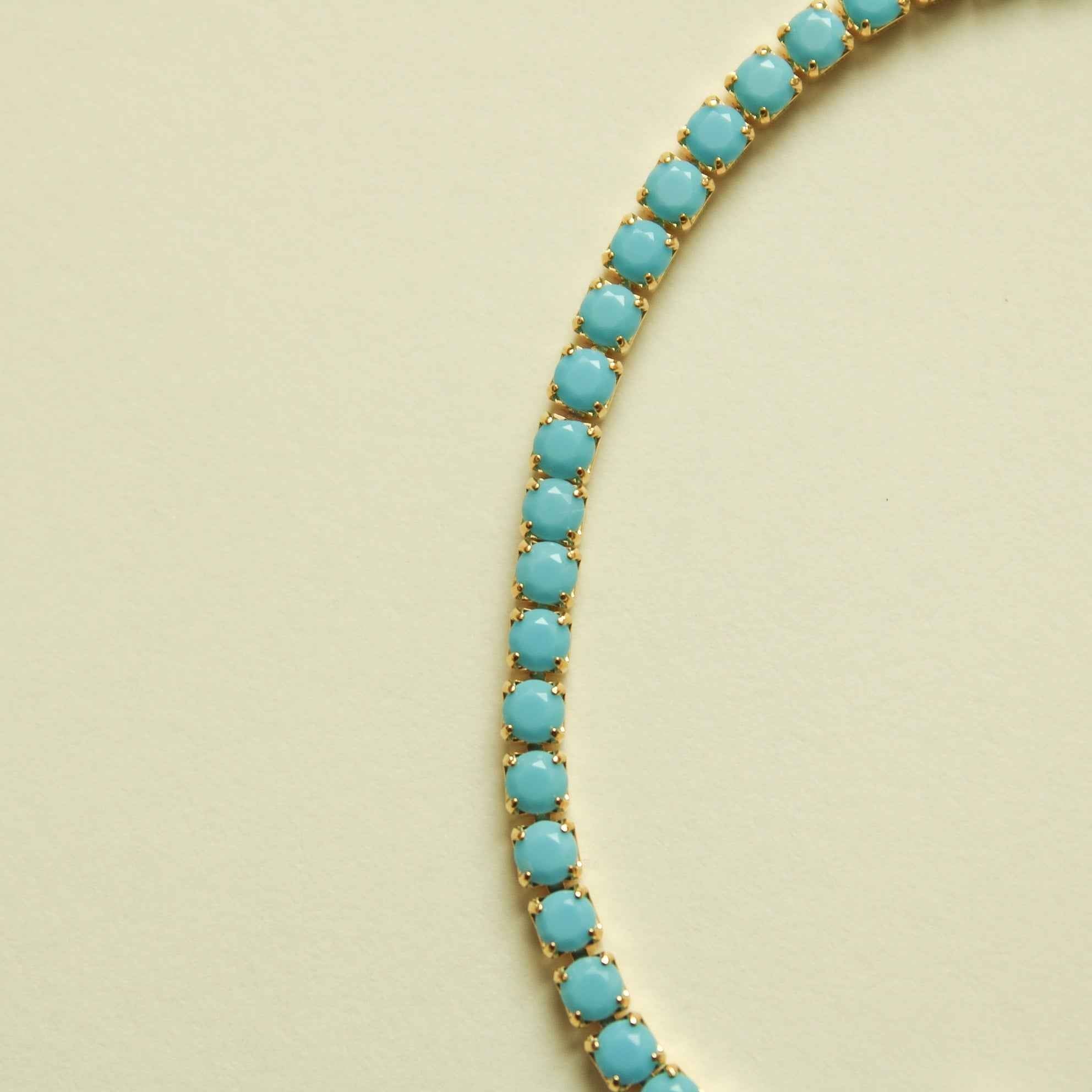 Turquoise beaded tennis bracelet strand with oval stones and gold links