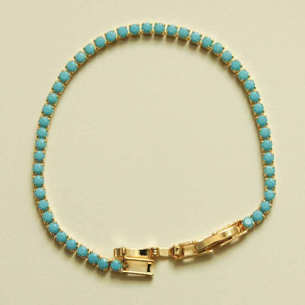 Turquoise beaded tennis bracelet with gold bar clasp and turquoise oval stones