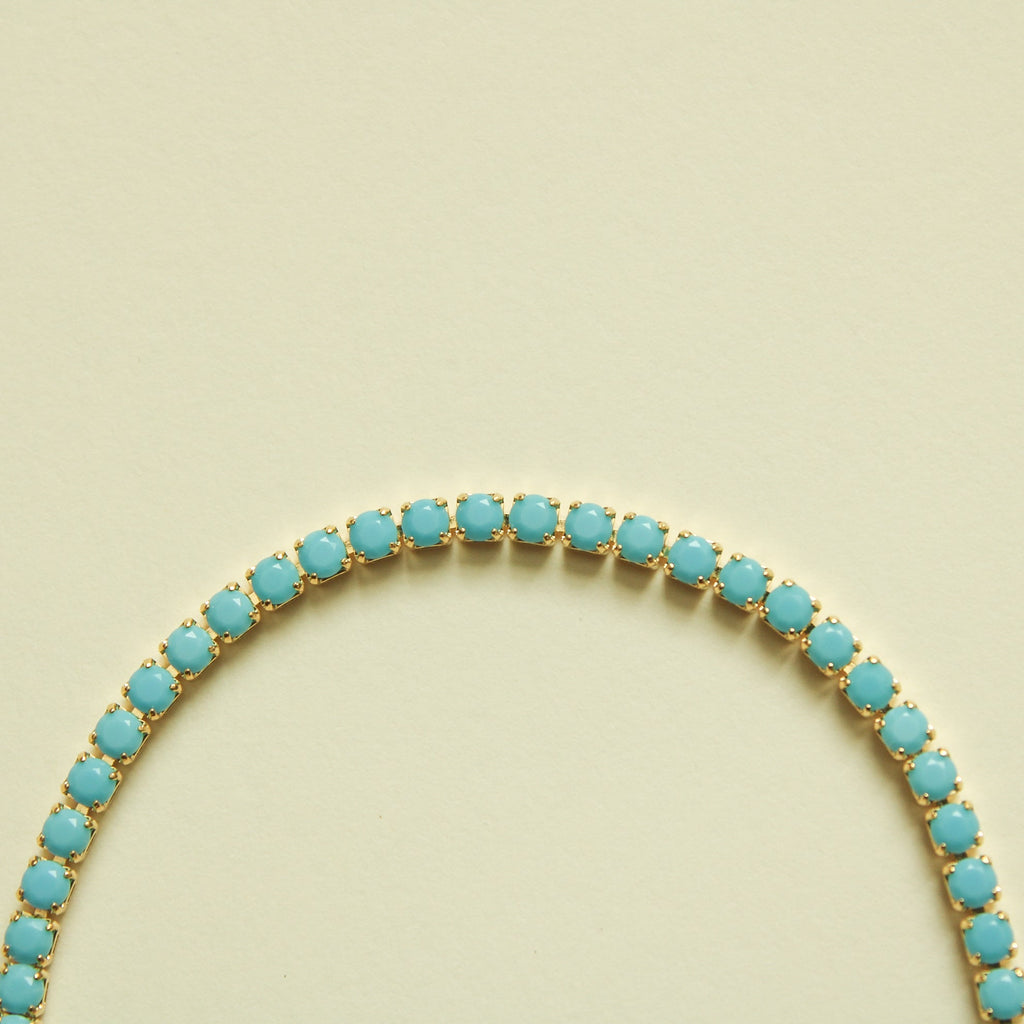 Turquoise beaded tennis bracelet arc with oval stones on gold base
