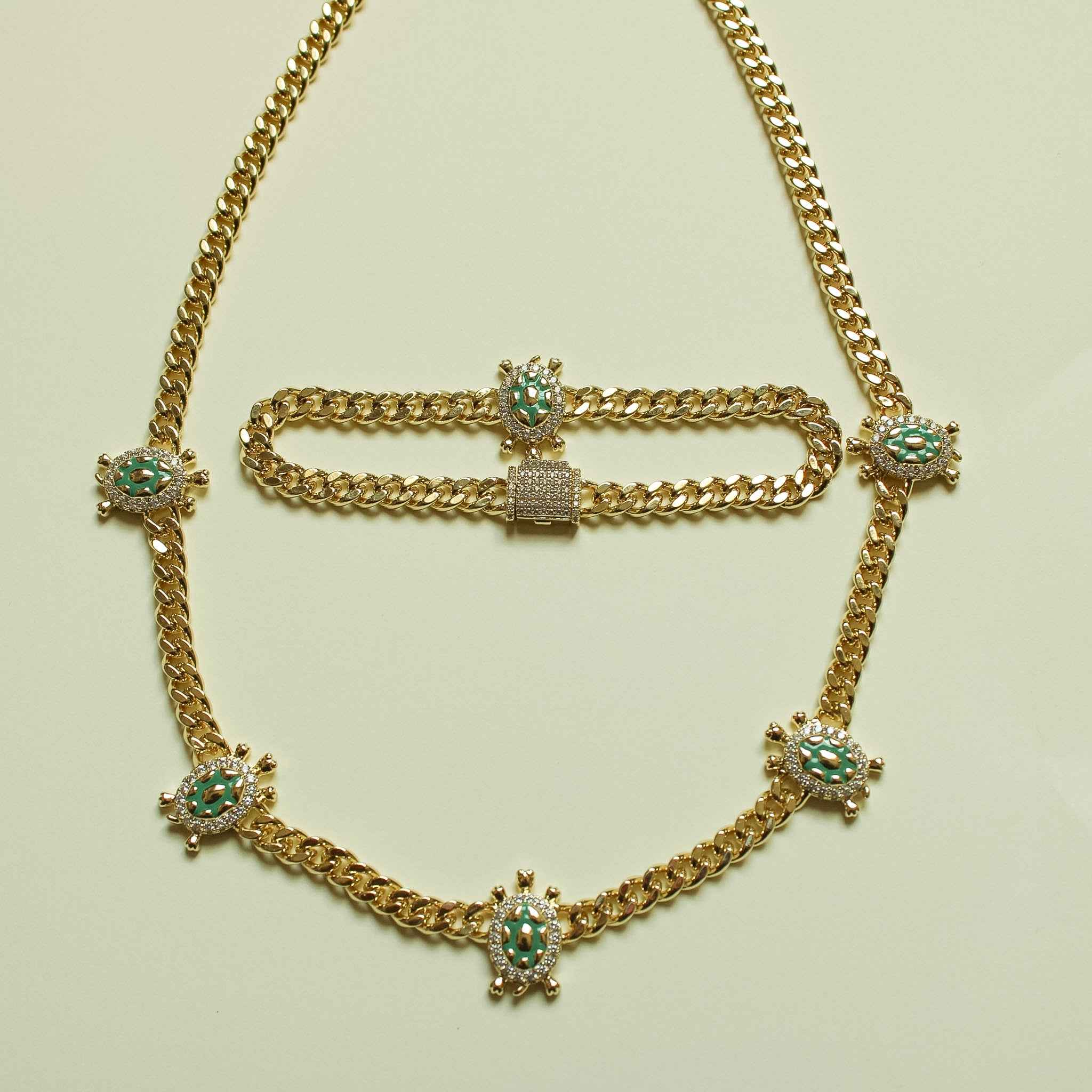 Gold Cuban chain necklace and bracelet set with green turtle charms on the links