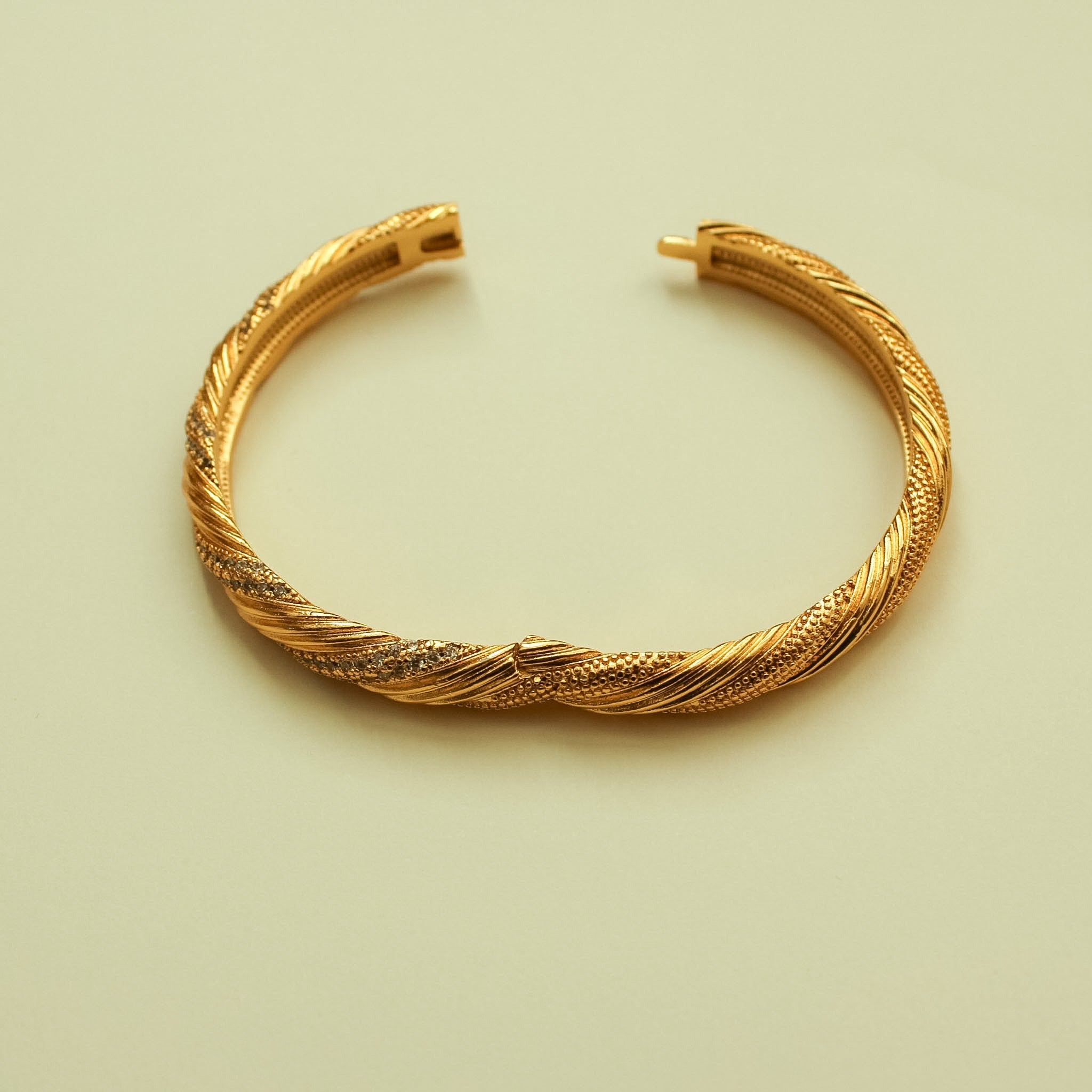 Twisted 22K gold pavé bangle bracelet with open cuff and rope texture