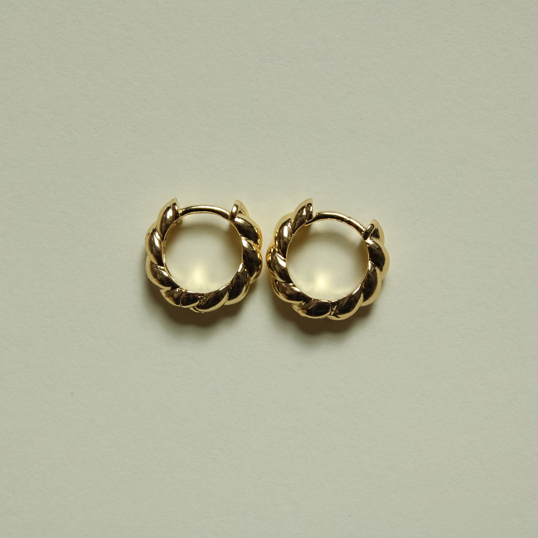 Twisted huggie hoop earrings, gold-tone twisted links in a round hoop