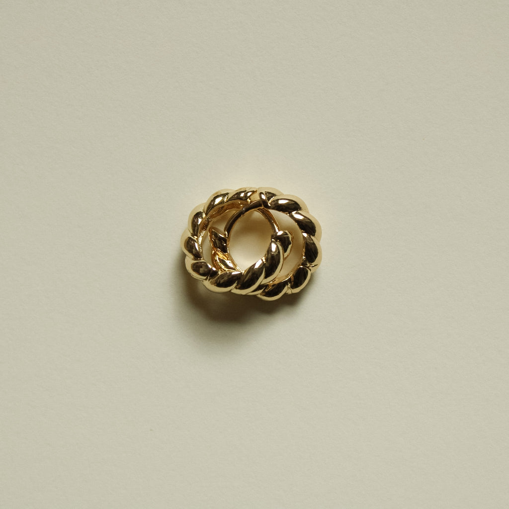 Gold-tone twisted huggie hoop earring with interlinked oval twists