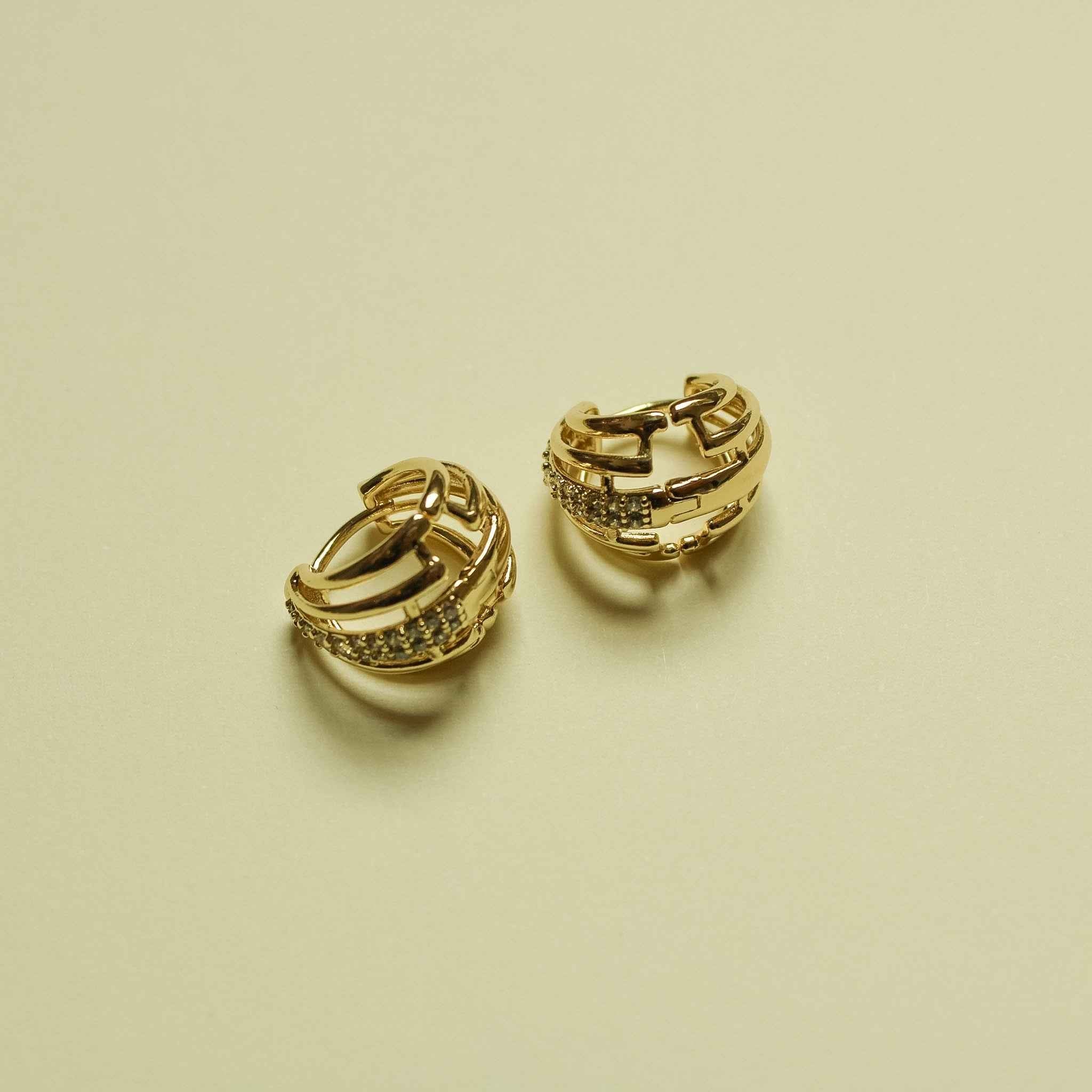 Wide pavé CZ huggie hoop earrings in 14K gold, shown as a pair